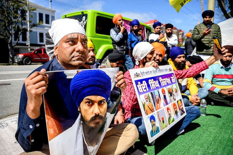 Raman Singh, left, holds a photo of Bhai Amritpal Singh at a protest against the Indian government outside the Indian consulate in San Francisco.  AFP