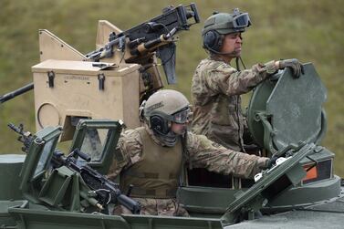 In this file photo taken on May 12, 2017, US soldiers sit in a tank type 'M1A2 SEP' during the exercise 'Strong Europe Tank Challenge 2017' at the exercise area in Grafenwoehr, Germany. AFP