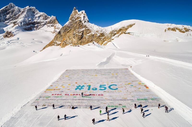 A photo taken with a drone shows a giant postcard of approximately 2,500 square metres  and made of contributions from over 125,000 individual postcards containing messages aiming to fight climate change and global warming, is pictured on the Aletsch glacier in Switzerland. EPA