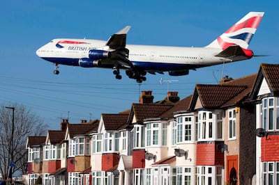 (FILES) In this file photo taken on February 18, 2015 a British Airways 747 aircraft flies over roof tops as it comes into land at Heathrow Airport in west London. Plans for a third runway at Heathrow airport are set to be approved by ministers on June 5, 2018. / AFP / Justin TALLIS
