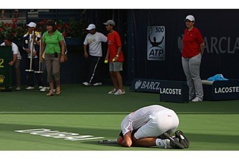 Novak Djokovic crumbles to the ground after defeating Russia's Mikhail Youzhny.