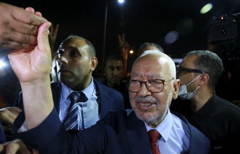 Rached Ghannouchi, head of Tunisia's Islamist Ennahda party, greets his supporters as he leaves the office of Tunisia's counter-terrorism prosecutor in Tunis on July 19, 2022.  AFP