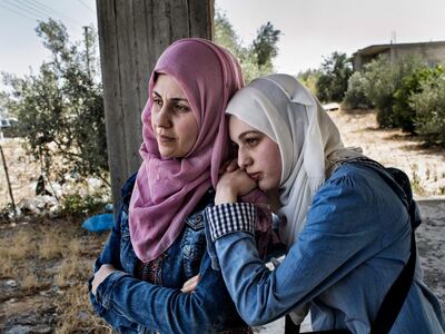 Here, a woman named Sally waits for a visa to come through so she can study medicine in Germany. 