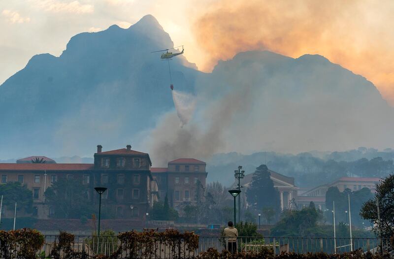 A helicopter tries to douse the blaze that destroyed the Jagger Library, dating back almost 200 years, on the University of Cape Town campus. EPA