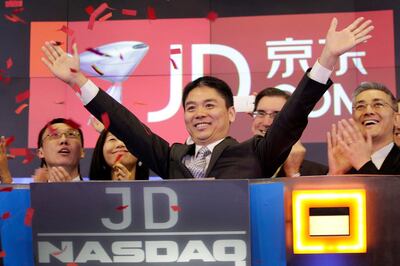 FILE - In this file photo taken May 22, 2014, Liu Qiangdong, also known as Richard Liu, CEO of JD.com, raises his arms to celebrate the IPO for his company at the Nasdaq MarketSite, in New York. A woman who said she was raped by Liu filed a lawsuit Tuesday, April 16, 2019, against the billionaire and his company alleging he and other wealthy Chinese executives coerced her to drink during a dinner in the hours before she was attacked. (AP Photo/Mark Lennihan, File)