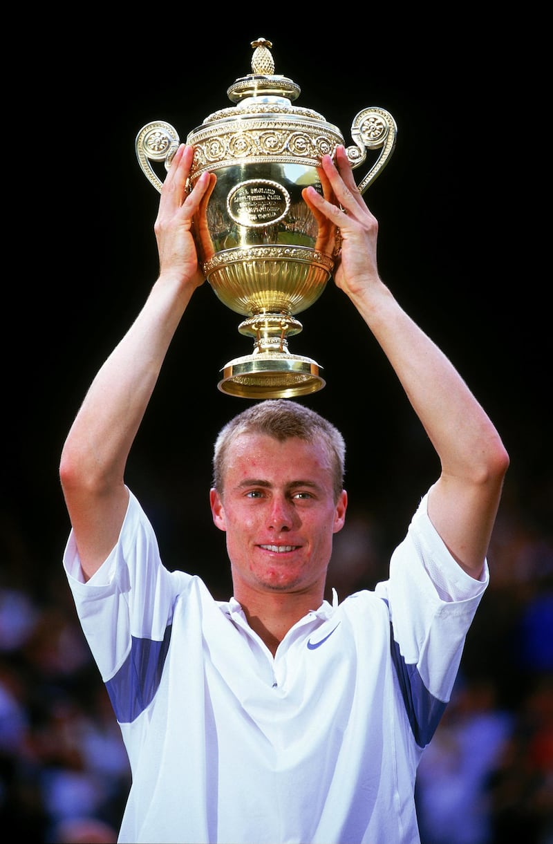 WIMBLEDON - 7 JULY:  Lleyton Hewitt of Australia lifts the trophy after victory over David Nalbandian of Argentina in the Men's Singles Final of the Lawn Tennis Championships at the All England Club in Wimbledon, England on July 7, 2002. Hewitt won 6-1, 6-3, 6-2. (photo by Clive Brunskill/Getty Images)