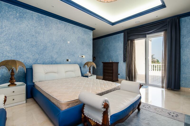 A bedroom with a balcony looking out over the garden. Photo: Engel and Voelkers
