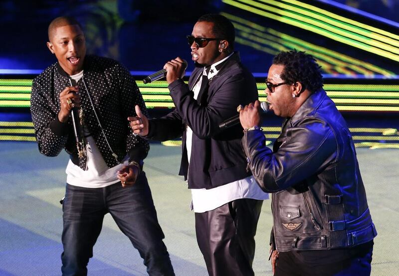 US rap singers Pharrell Williams, left, Sean ‘Ditty’ Combs, centre, and Busta Rhymes, right, perform during the 63rd NBA All-Star Game. Dan Anderson / EPA