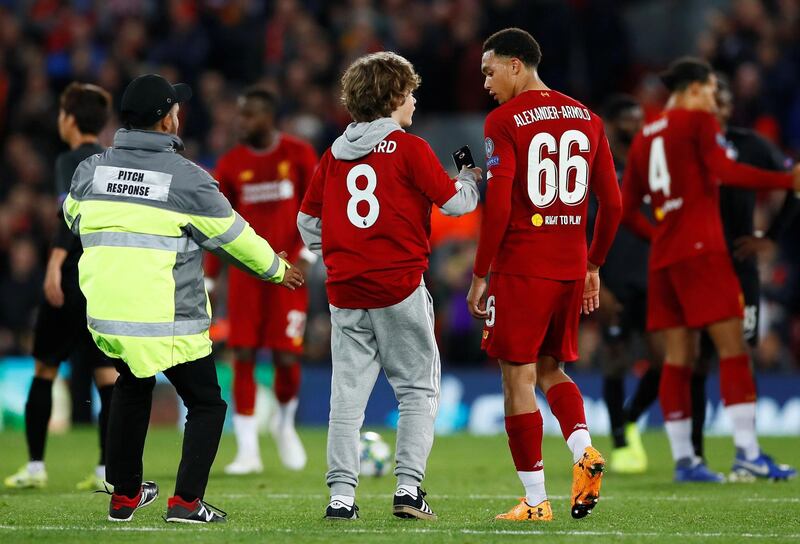Liverpool's Trent Alexander-Arnold and a pitch invader after the match. Action Images via Reuters
