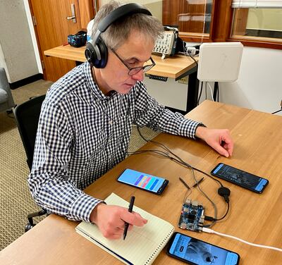 Reporter Andrew Buncombe testing the headphones in the University of Washington lab. Andrew Buncombe / The National