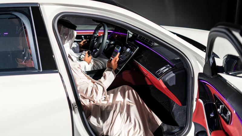 Visitors sit in the new S-Class.