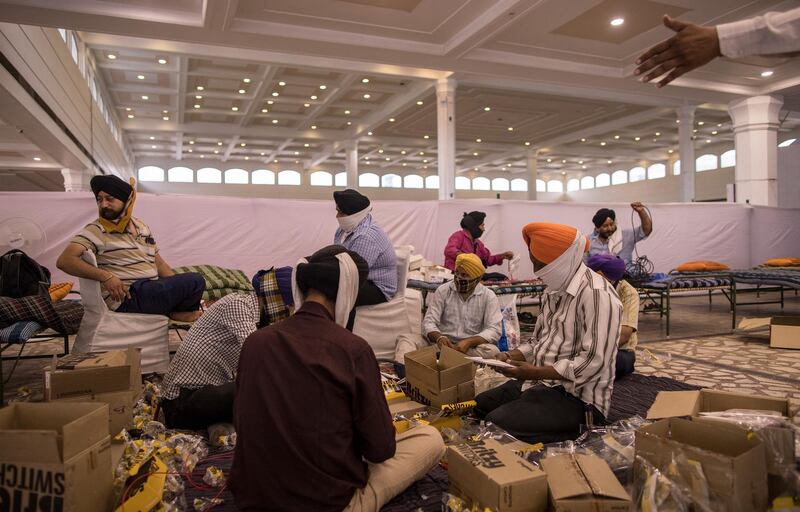 Sikh devotees work as volunteers at a gurdwara in New Delhi after the Sikh shrine was partially converted into Covid care centre, amid a surge in cases in Indian capital. Anindito Mukherjee/Getty Images