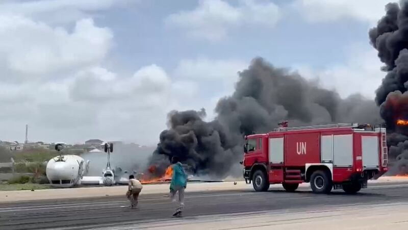 Smoke billows from a plane that flipped over after a crash landing, in Mogadishu, Somalia in this picture obtained from social media. Photo: Abdirahman Mohamed Arab via Reuters