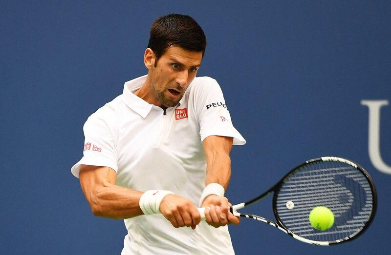 Novak Djokovic returns a shot to Mikhail Youzhny during their third-round match on Friday. Alex Goodlett / Getty Images