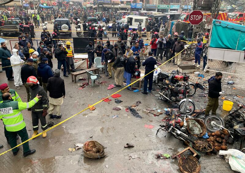 Officials examine the site of the explosion in Lahore. AP