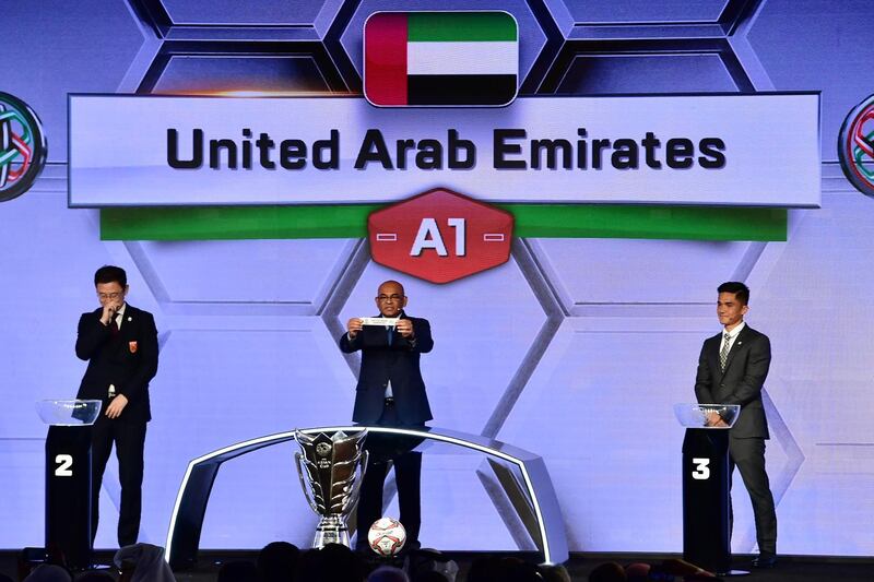 AFC general secretary Dato' Windsor John displays the slip of the United Arab Emirates during the final draw for the 2019 AFC Asian cup championship held in the Gulf emirate of Dubai on May 4, 2018. / AFP PHOTO / GIUSEPPE CACACE
