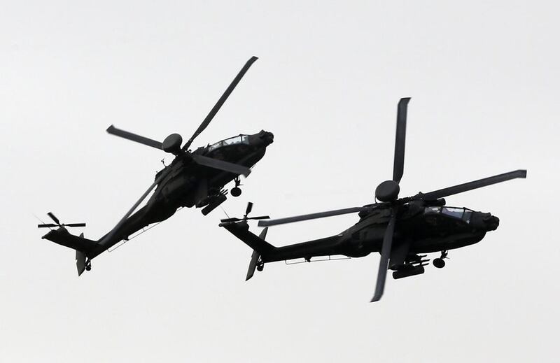 Helicopters of the UAE armed forces fly during the military show at the opening of Idex 2015. AFP

