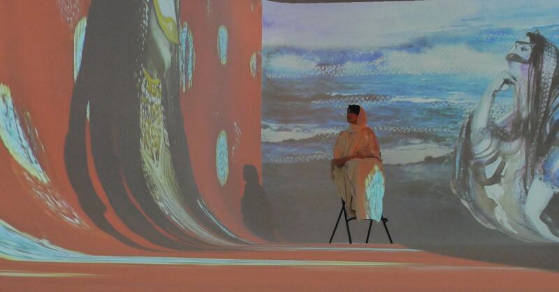 To showcase her work, Abdulla filmed a video of herself walking around a space with her paintings projected on the walls