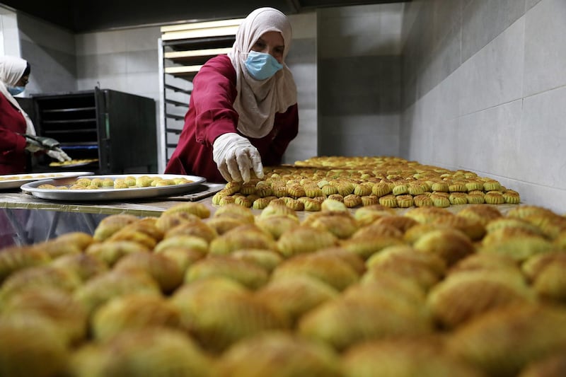 A Palestinian woman prepares traditional biscuits in the West Bank city of Hebron.  EPA