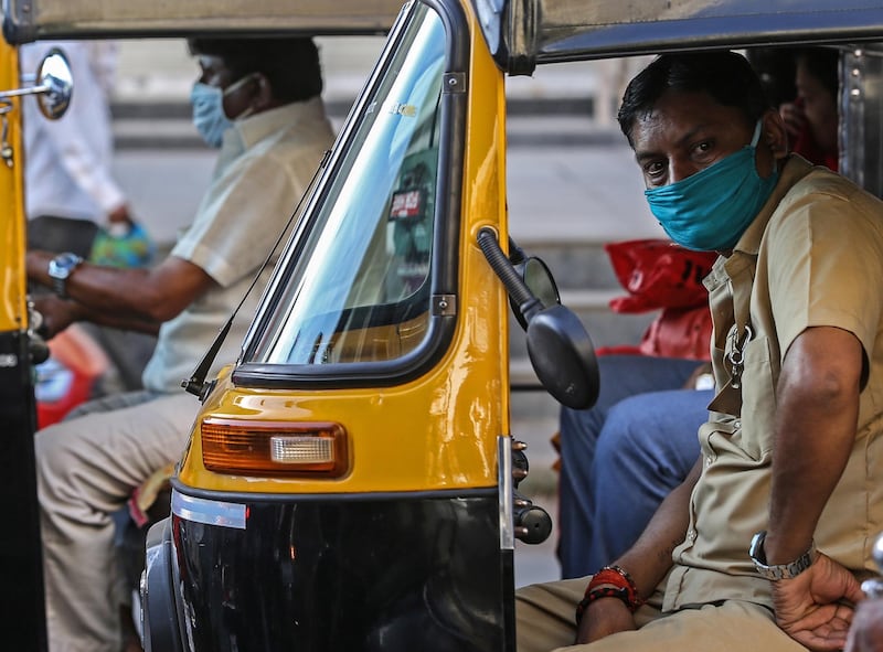 Autorickshaw drivers cover their faces as a precaution against the ongoing pandemic of the Covid-19 disease, in Mumbai, India.  EPA