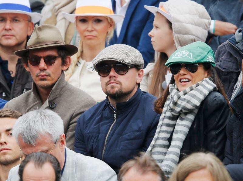 U.S. actor Leonardo DiCaprio (C) watches the men's singles final match between Rafael Nadal of Spain and compatriot David Ferrer at the French Open tennis tournament at the Roland Garros stadium in Paris June 9, 2013.   REUTERS/Gonzalo Fuentes (FRANCE  - Tags: SPORT TENNIS ENTERTAINMENT)   *** Local Caption ***  RGT924_TENNIS-OPEN-_0609_11.JPG