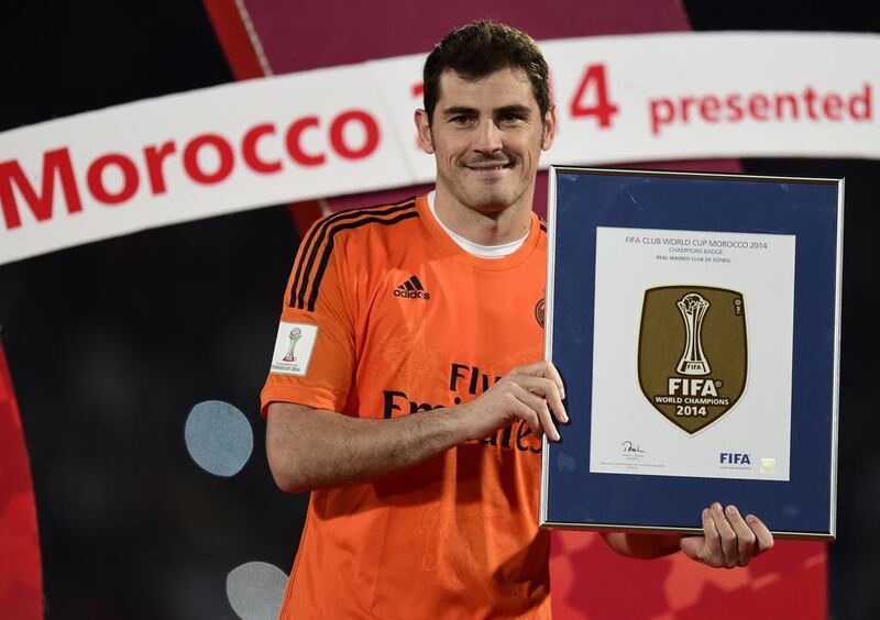 Real Madrid’s goalkeeper Iker Casillas poses with a trophy at the end of the FIFA Club World Cup final football match against San Lorenzo at the Marrakesh stadium in the Moroccan city of Marrakesh on December 20, 2014. Real Madrid defeated San Lorenzo of Argentina 2-0 to win the Club World Cup and secure their fourth trophy of 2014. Casillas, 33, caps his 700th appearance for Real Madrid, ranking him third overall for the highest number of appearances for the club. AFP PHOTO / JAVIER SORIANO