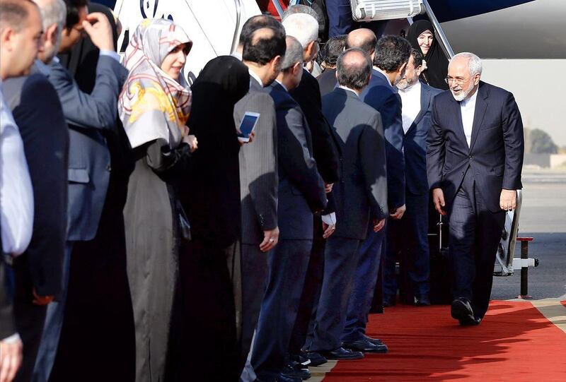 Iranian foreign minister Mohammad Javad Zarif (R) greets Iranian officials as he and members of his negotiation team arrive at the Mehrabad airport in Tehran on July 15, 2015. Abedin Taherkenareh/EPA