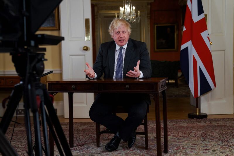 Mr Johnson speaks to update the nation from Downing Street on the Covid-19 booster vaccine programme on December 12. AFP