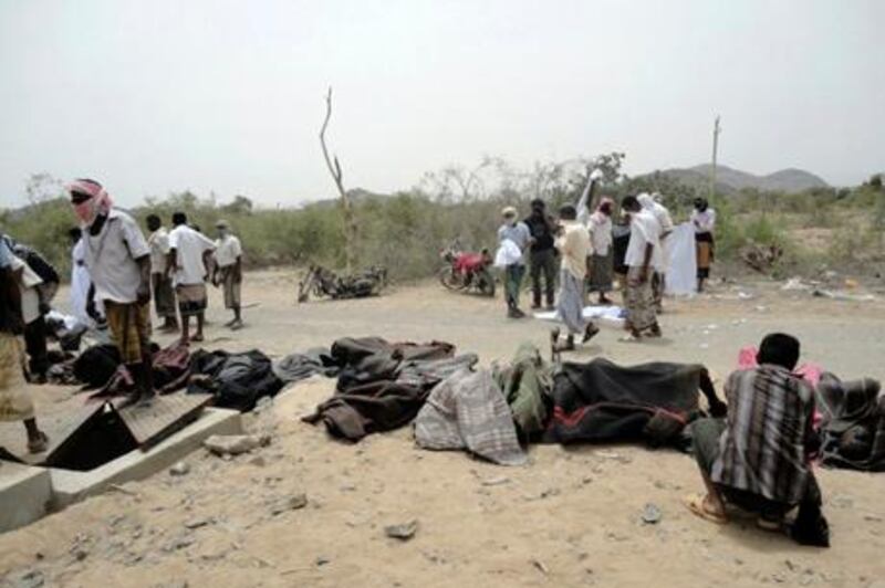 Tribesmen stand near bodies of victims of an explosion at a bullet factory in the southern Yemeni town of Jaar March 27, 2011. The death toll in an explosion at a south Yemen bullet factory on Monday rose to at least 110, and more bodies were expected to be recovered, doctors said. Witnesses said the blasts, possibly triggered by a cigarette, caused a massive fire in the factory in the town of Jaar in Abyan province, where al Qaeda militants and mainly leftist southern separatists are active. REUTERS/Stringer (YEMEN - Tags: POLITICS CIVIL UNREST IMAGES OF THE DAY) *** Local Caption ***  SAN03_YEMEN-DEAD-_0328_11.JPG