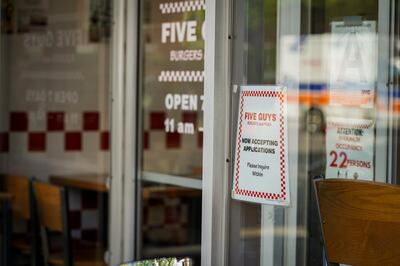 A help wanted sign posted outside a Five Guys location in New York City on May 19, 2021. Joshua Longmore / The National 