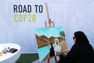 Artist painting during the Road to COP28 Launch Event held at Jubilee Park at the EXPO City in Dubai. Pawan Singh / The National