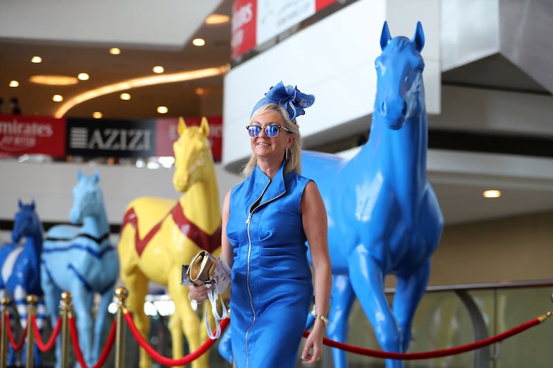 A guest enters Meydan Racecourse before the start of Dubai World Cup. Pawan Singh / The National