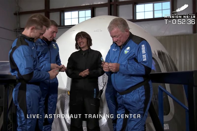 Chris Boshuizen, Glen de Vries, Audrey Powers and William Shatner are presented with commemorative coins before their suborbital flight. Reuters