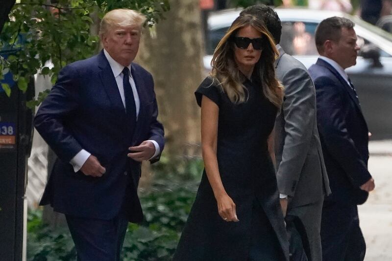 Donald Trump walks with wife Melania to the funeral. AP