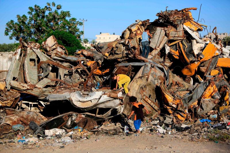 Palestinian children play with scrap metal in the southern Gaza Strip refugee camp of Khan Yunis.  
AFP