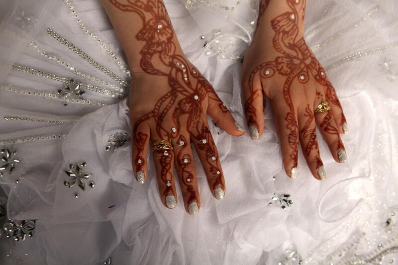 A young  Palestinian bride's hands are decorated with red henna and sequins for her wedding  in Beit Hanounin northern Gaza on May 12,2011 . (Photo by Heidi Levine/Sipa Press). 