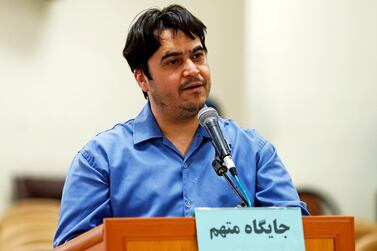 Journalist Ruhollah Zam, a journalist whose online work helped inspire the 2017 economic protests and who returned from exile to Tehran, speaks during his trial ahead of a death sentence verdict. Mizan News Agency via AP