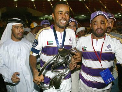 Al Ain (United Arab Emirates) player Salem Jawhar Salmeen J.(C) celebrates with the trophy during the AFC Champions League final, second leg in Bangkok, 11 October 2003. Al Ain of United Arab Emirates won the AFC Champions after a total score of 2-1 (2-0 in first leg).   AFP PHOTO/Pornchai KITTIWONGSAKUL (Photo by PORNCHAI KITTIWONGSAKUL / AFP)