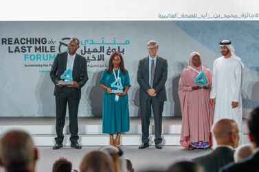 Abu Dhabi, United Arab Emirates, November 19 , 2019. Reaching the Last Mile Forum. Recipients of the Reach awards at the Reaching the Last Mile forum at Louvre Abu Dhabi on Tuesday. (L-R) Richard Kojan, Olivia Ngou and Rahane Lawal worked to tackle polio, Ebola and malaria with Bill Gates and H.E. Sheikh Mohamed bin Zayed, Crown Prince of Abu Dhabi and Deputy Supreme Commander of the UAE. Victor Besa / The National Section: NA Reporter: Dan Sanderson