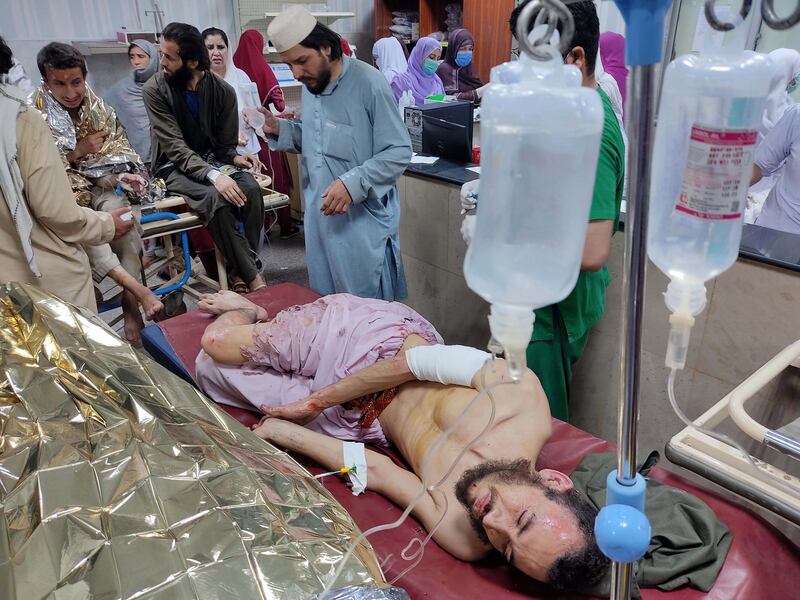 People who were injured in an explosion at an Islamic seminary receive medical treatment at a hospital in Peshawar, Pakistan.  EPA