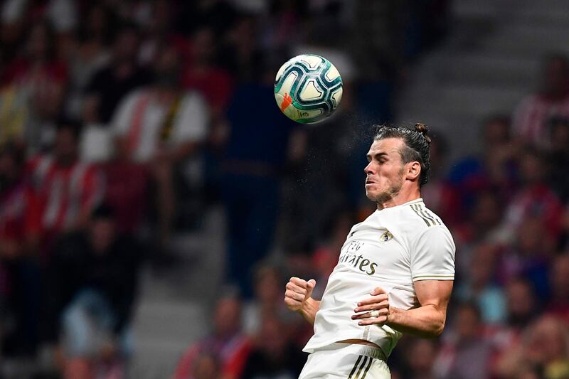 Real Madrid's Welsh forward Gareth Bale jumps for the ball during the Spanish league football match between Club Atletico de Madrid and Real Madrid CF at the Wanda Metropolitano stadium in Madrid on September 28, 2019. / AFP / OSCAR DEL POZO
