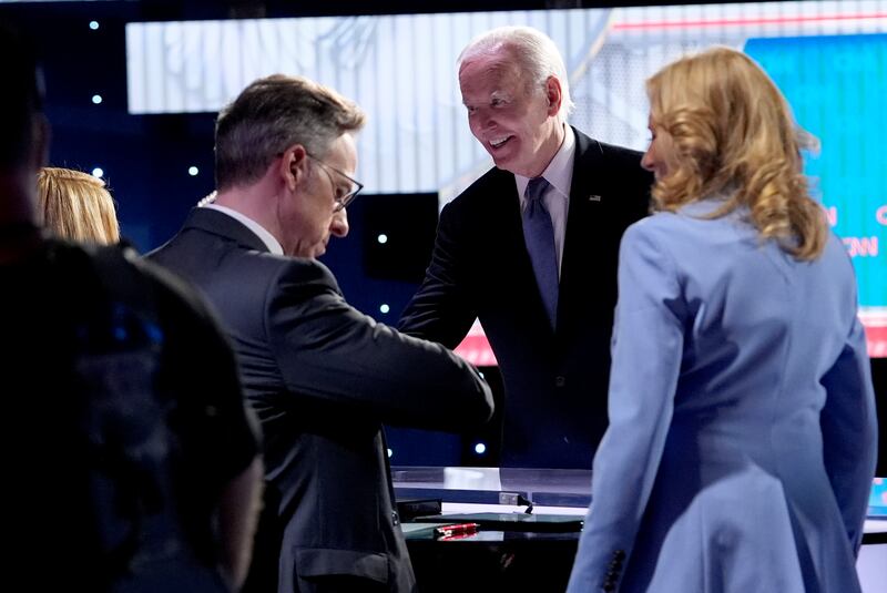 Mr Biden and his wife Jill greet CNN event moderators Dana Bash and Jake Tapper after the debate. AP