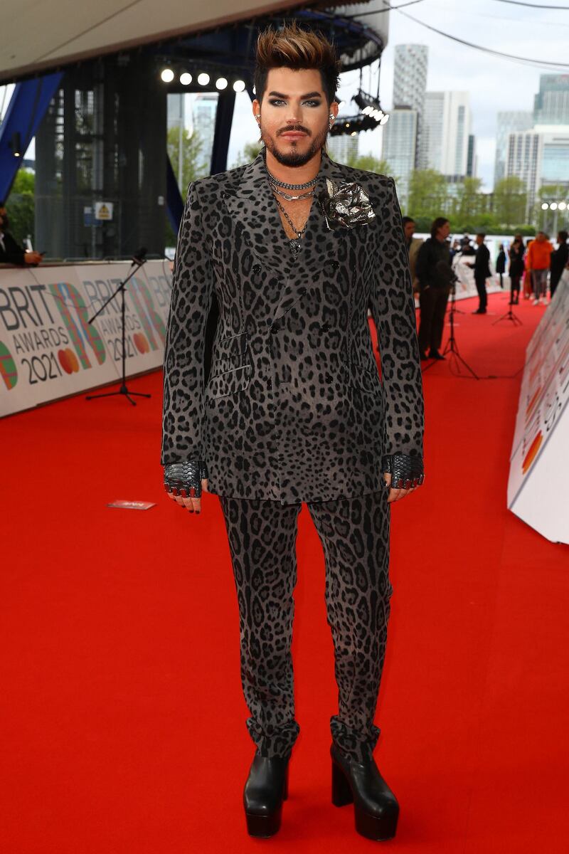 Adam Lambert attends the Brit Awards 2021 red carpet in an animal print suit. AFP