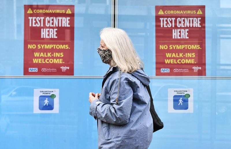 NEWCASTLE-UNDER-LYME, ENGLAND - MAY 12: A lady wearing a mask walks past a walk in coronavirus test centre on May 12, 2021 in Newcastle-Under-Lyme, England . (Photo by Nathan Stirk/Getty Images)