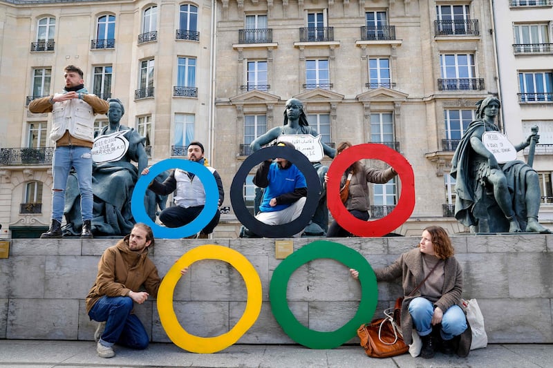 Activists pose with Olympic rings outside the Orsay Museum in Paris, during a demonstration to draw attention to social inequality they say will be exacerbated by the coming event. AFP