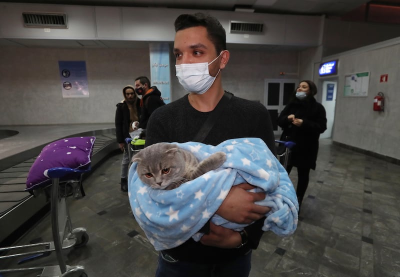 A Tunisian arrives with his cat in Tunis. EPA