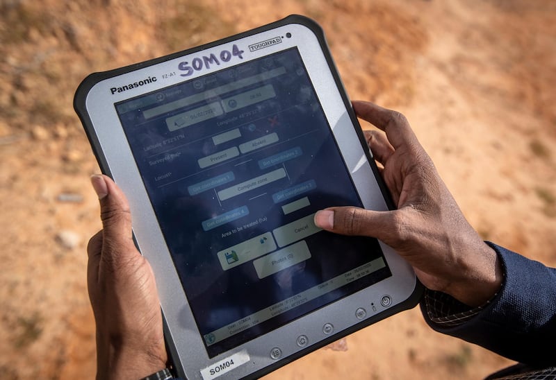 An official from the Food and Agriculture Organization demonstrates the "eLocust3" software used to record and track the location and movements of locusts using GPS. AP