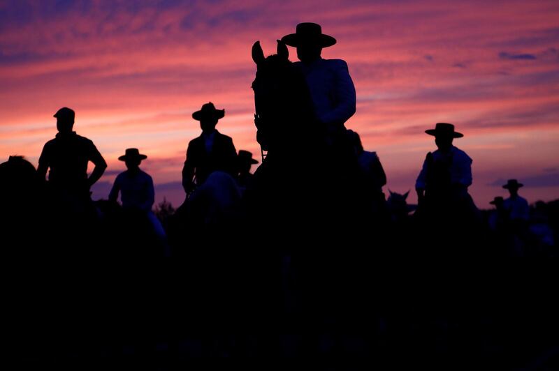 Horse riders are silhouetted against the rising sun as they take part in the traditional 'Piostros' fiesta in Pedroche, Cordoba, Spain.  EPA