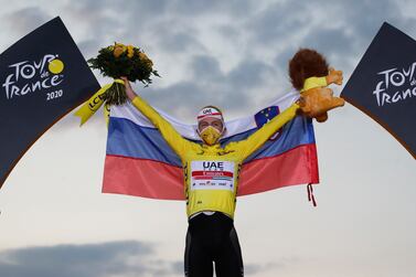 Cycling - Tour de France - Stage 21 - Mantes-la-Jolie to Paris Champs-Elysees - France - September 20, 2020. UAE Team Emirates rider Tadej Pogacar of Slovenia celebrates on the podium, after winning the general classification and the overall leader's yellow jersey. REUTERS/Stephane Mahe