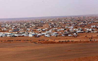 FILE - This file picture taken Tuesday, Feb. 14, 2017, shows an overview of the informal Rukban camp, between the Jordan and Syria borders. Statements issued by the United Nations and the Syrian Arab Red Crescent said their joint convoy reached Rukban camp and would deliver assistance to 50,000 people The convoy was supposed to arrive last week but was delayed due to logistics and security concerns. The U.N. said the operation is expected to take three to four days. (AP Photo/ Raad Adayleh, File)